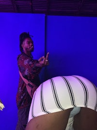 a man is standing next to a woman in a white skirt