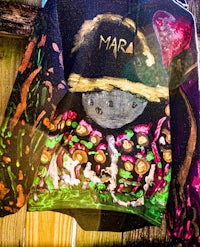 a hooded sweatshirt hanging on a fence