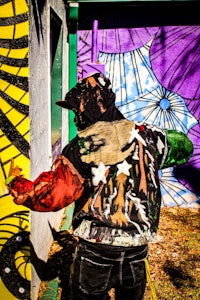 a man is painting a mural on a wall